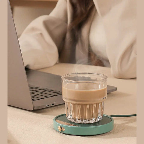 Smart Electric Coffee Mug Warmer Triple Temperature Settings Digital Display keeping coffee warm on desk next to laptop.