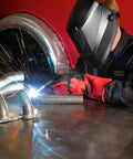 Person wearing K2800-1 4.5 By 5.25 Inch Auto Darkening Weld Helmet With Grade Ten Lens working on metal pipe welding.