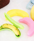 Reusable Banana Keeper Guard With Secure Snap Lid Keeps Bananas Fresh And Prevents Bruising For Tailgate Days Camping Trips And Backyard Hangouts portable fruit travel case with banana inside a green holder.
