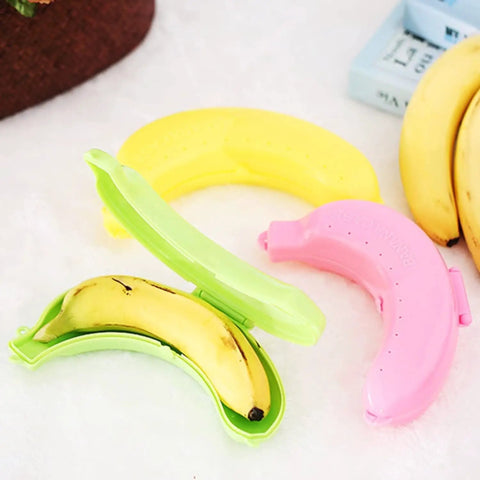 Reusable Banana Keeper Guard With Secure Snap Lid Keeps Bananas Fresh And Prevents Bruising For Tailgate Days Camping Trips And Backyard Hangouts portable fruit travel case with banana inside a green holder.
