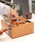 Espresso Tamping Station With Knock Box And Solid Wood Filter Holder Fits 58Mm Portafilters, shown with tamping process.