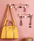Gotta Have These Killer Wrought Iron Love Wall Hooks For Keys Hats And Scarves With A Totally Dope European Touch Black Metal Row Bar For Your Entryway Flex Size 39X8cm with a yellow handbag and accessories.