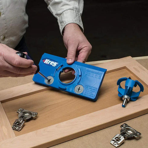 Person using KHI Hinge Concealed Jig And KHC Premium Face Clamp Set Blue Pro Grade for DIY woodworking on cabinet door.