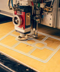 Clear Acrylic Nine Pocket Router Jig And Tracing Template For Woodworking Shops positioned over wood for precise routing.