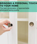 Hand installing Antique Brass Cabinet Knobs 25 Pack With Screws 1.2 Inch Round Cabinet Door Knobs on white cupboard door