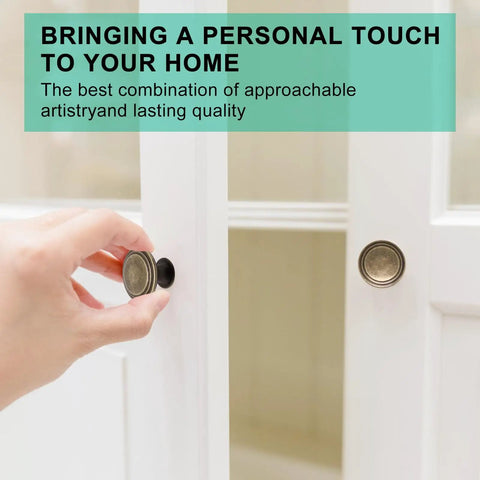 Hand installing Antique Brass Cabinet Knobs 25 Pack With Screws 1.2 Inch Round Cabinet Door Knobs on white cupboard door