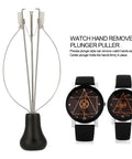 Spring Loaded Watch Hand Puller Tool For Safe Hand Removal next to two black watches with geometric dials.