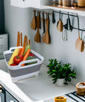 Collapsible Wash Basin With Drain Plug 2.4 Gallon Foldable Kitchen Sink holding vegetables on a counter