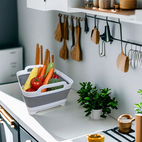 Collapsible Wash Basin With Drain Plug 2.4 Gallon Foldable Kitchen Sink holding vegetables on a counter