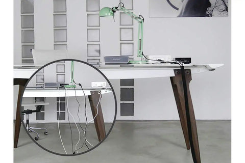 Desk setup showing self closing cable sleeve for flexible cable management at desks, PCs, TVs, heat fire and UV resistant, black