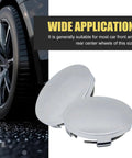 Universal Car Wheel Center Caps 60mm OD 56mm ID 4 Pack Durable Scratch Resistant And Rust Proof ABS Snap In Hub Caps For Cars SUVs Trucks All Weather Ready Silver beside a car tire