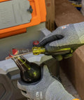 Bottle Opener For Pros With Cushioned Grip Handle And Tip Ident For Quick ID In Pouches Made In USA being used on bottle.