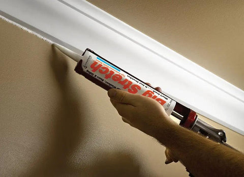 Applying Big Stretch Caulk Dark Brown 10.5 Ounce Tube For Indoors And Outdoors Use DIY Friendly Super Elastic Sealant to crown molding