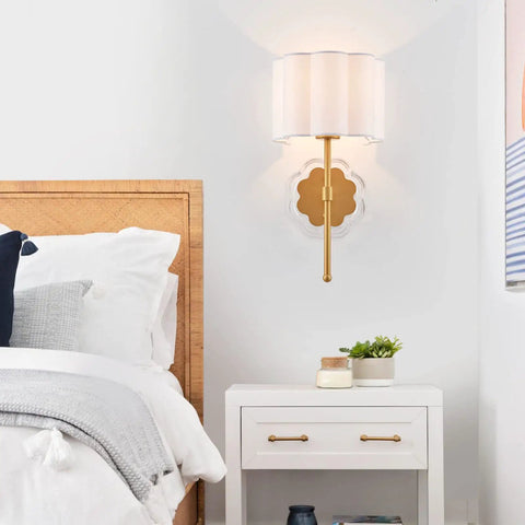 Bedroom view of set of 2 modern wall sconces with creamy white fabric flower shades and antique brass brush finish, UL listed