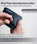 Hands opening the Waterproof Minimalist Pouch For Outdoors Junkies to reveal airtight zipper, textured black TPU material.