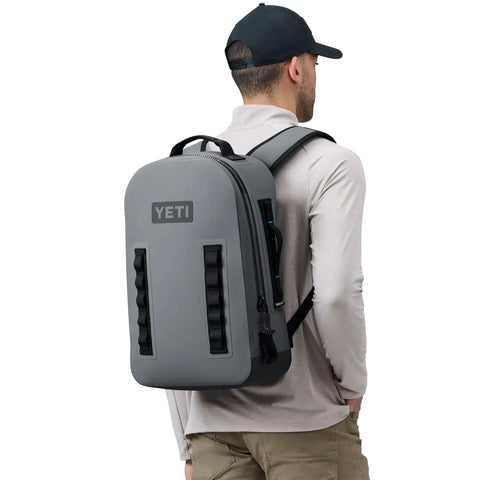 Man wearing Panga 28 Airtight Waterproof Submersible Backpack with DryHaul ergonomic straps in Storm Gray, side view