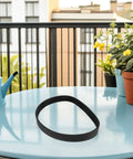Mower Belt Black Rubber Drive Belt For Lawn Tractor Replacement Upgrade For Consistent Mowing And Smooth Deck Performance Heavy Duty Beefy Build Ideal For Garden Tools And Trimmers Easy Install Keeps Your Yard Looking Sharp. black rubber drive belt on glass table