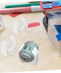 ARTIBETTER white plastic motor clamp brackets for small DC geared motor; 3-piece set shown with gray motor