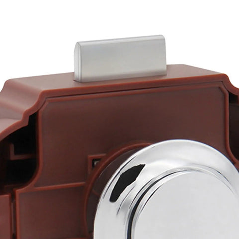 Close-up of brown RV push button latch lock for cabinet drawer with chrome button, 26mm diameter