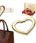 Gold Finish 22K Purse Hook For Table, Heart Shaped Portable Handbag Holder For Desk Travel Cafe And Office shown in use and packaging