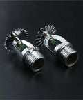 Heavy-Duty Bronze Pendent Fire Sprinkler Heads with Rock-Solid 93 Degree Activation rated for 1/2 Inch NPT Down Type Mounts for Gyms Schools and Public Venues bringing No-Nonsense Extinguishing System Safety to your Premises in a 5 Piece Load built to - close-up of two sprinkler heads with shiny metallic finish.