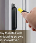 2 Pack Black Aluminum Barn Door Handles With 5 Inch Center Hole Sliding Closet Door Pulls being installed with screwdriver