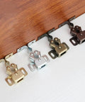 Four Piece Cabinet Door Catches Featuring Bulletproof Magnetic Dampers And Adjustable Metal Mounts For Kitchens And Wardrobes With A Dead Simple Install That Delivers Slick Soft Close Action Every Time, showing different finishes on catches.