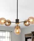 Six Light Glass Globe Sputnik Chandelier In Matte Black With Amber Shade For Kitchen Island Dining Room Living Room Modern Mid Century Pendant Lamp For Home Decor in a living room.