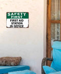 First Aid Station Aluminum Sign 8x12 Inches Dope Wall Decor For Office, mounted on white wall next to chair and window