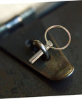 Close-up of a galvanized pin lock from Ten Pack Safety Pin Locks For Lawn Mower Trailers And Farm Equipment Heavy Duty Lynch Pin Retainer Kit Corrosion Resistant Galvanized Pins For Tractors And Trucks on metal surface