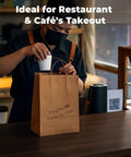 Person placing cup in Heavy Duty Kraft Paper Bags With Handles 10 x 7 x 12 Inches, 250 Pack Brown Shopping Bags For Grocery, Gift And Retail Carry, Eco Friendly Recyclable Bags on counter.