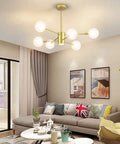 Sputnik Chandelier In Gold Finish, 6 Light Built-In Dimmable LED Spotlight illuminating modern living room with glass globe orbs.