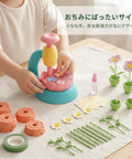 Kids DIY Craft Kit For Creative Imagination And Personal Art Projects At Home Fun Reusable Paper Materials That Inspire Creative Expression Through Hands On Crafting And Colorful Family Friendly Fun, child assembling paper flower craft kit on table