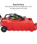 Two people lifting a red Flo N Go 14 Gallon Gas Caddy On Wheels With 53 Liter Portable Fuel Tank And Built In 10 Foot Hose And Fuel Transfer Pump
