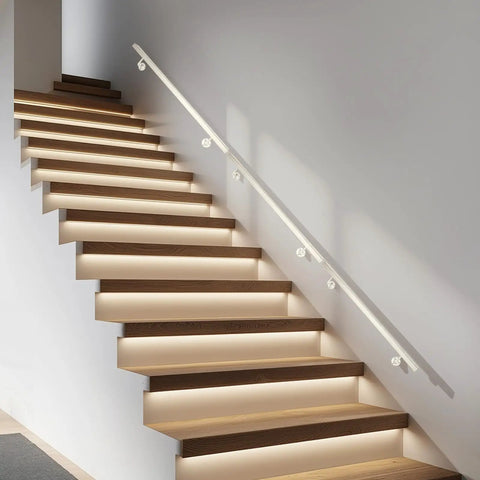 Built Tough Stainless Steel Stair Handrail Wall Mounted Safety Grip Bar For Indoor Outdoor Steps Featuring Durable Baked Finish And Rock Solid Grip All Day Long on modern wooden staircase with soft lighting.