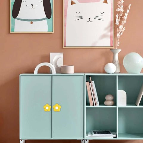 Yellow Flower Cabinet Knobs With Drawer Pulls For Closets Or Kids Rooms Super Smooth Soft Rubber Grip Over Solid Zinc Alloy Base 6 Piece Kit With Hassle Free Mounting Screws For A Quick Home Refresh on a mint green cabinet.
