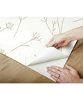 Person peeling Brown And White Twigs Peel And Stick Wallpaper Roll For Easy Wall Makeover, Nature Inspired Pattern, removable decor
