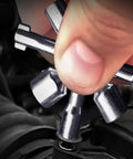 Close-up of a hand using the All In One 10 In 1 Carbon Steel Portable Screwdriver And Wrench Kit on a control cabinet.