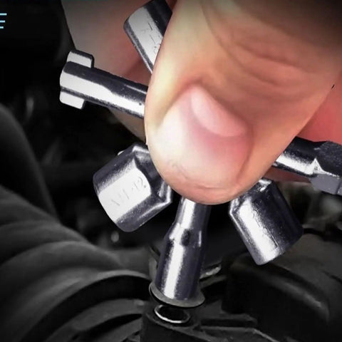Close-up of a hand using the All In One 10 In 1 Carbon Steel Portable Screwdriver And Wrench Kit on a control cabinet.