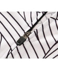 Close-up of black and white striped fabric with zipper detail