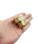 Beefy Lengthened Brass Extension Fittings 1 Inch By 1.25 Inch Adapter held in hand, shows thickened female pipe fitting and golden finish.
