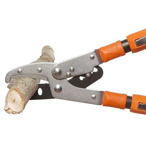 Super Tough Hybrid Blade Ratcheting Telescopic Lopper With Easy Adjust Handles cutting a branch, showing blade action in use