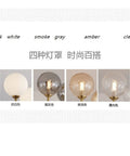 Nordic Minimalist Magic Bean LED Pendant Lamp French Glass Ball U-Shaped Chandelier in milk, smoke gray, amber, and clear options.