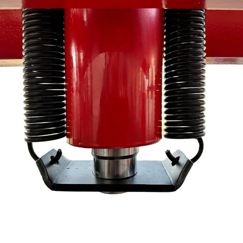 Close-up view of red hydraulic cylinder of 50 Ton Hydraulic Shop Press With H Frame Workhorse Adjustable Working Table Height Twenty Seven And A Half Inch Bed Seven And A Half Inch Stroke One Hundred Ten To One Hundred Twenty Five PSI Air Quarter Inch Inlet Zero To Forty Inch Work Range Garage.