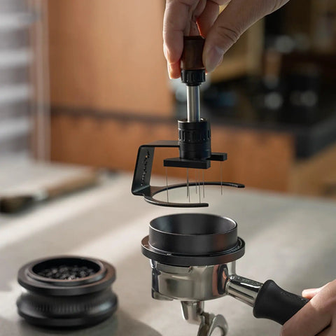 Game Changing 58mm Espresso Puck Distributor Tool with Adjustable Height and Eight Precision Needles in use over a portafilter.