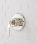 Signature Hardware Gunther 1.8 GPM Pressure Balanced Shower System metal handle and plate mounted on white hexagon tile.