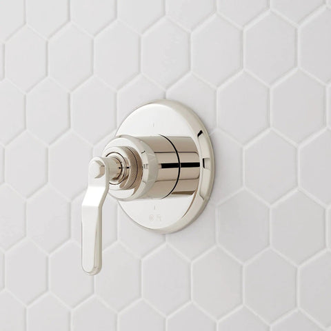 Signature Hardware Gunther 1.8 GPM Pressure Balanced Shower System metal handle and plate mounted on white hexagon tile.