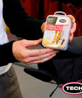 Person holding Ride Ready Bicycle Tube Patch Kit For Any Tire Inner Tube Or Tubeless Flat On The Go near bicycle saddle.