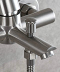 Close-up of stainless steel wall mounted tub faucet with brushed nickel finish, single lever, built-in aerator