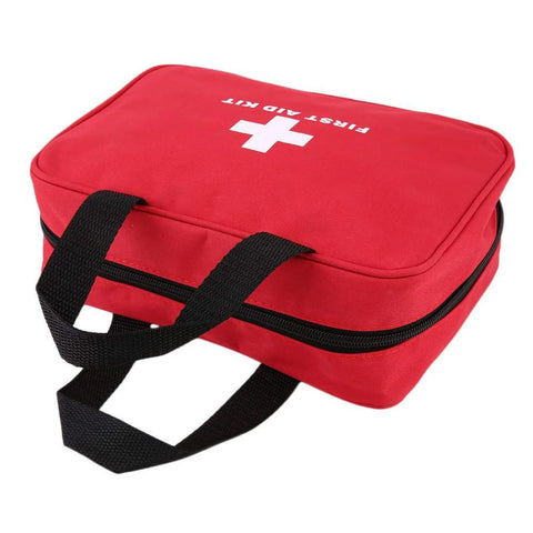 Red first aid kit bag with black handles and zip closure; front view, empty contents
